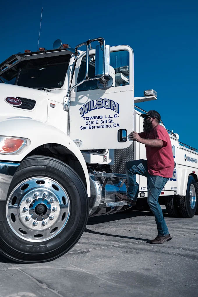 Heavy-Equipment-Towing-Tow-Truck-Operator-getting-in-tow-truck-in-San-Bernardino Heavy Equipment Towing Tow Truck Operator getting in tow truck in San Bernardino